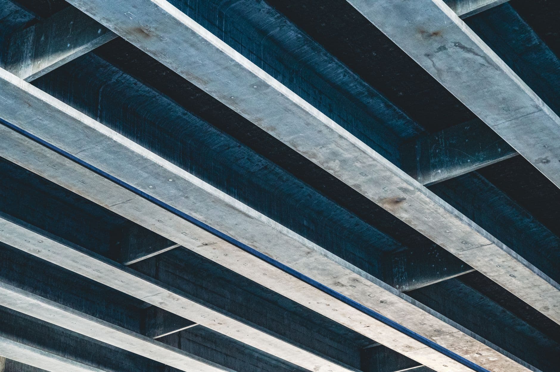 Low angle shot of an industrial steel and concrete ceiling structure.